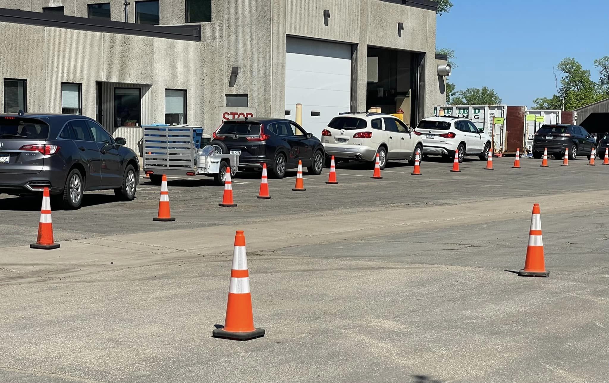 line of cars following orange cones 