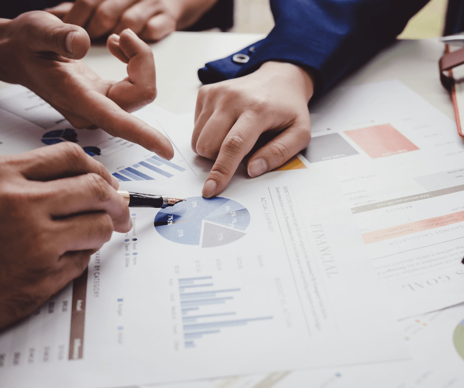 hands pointing to financial documents